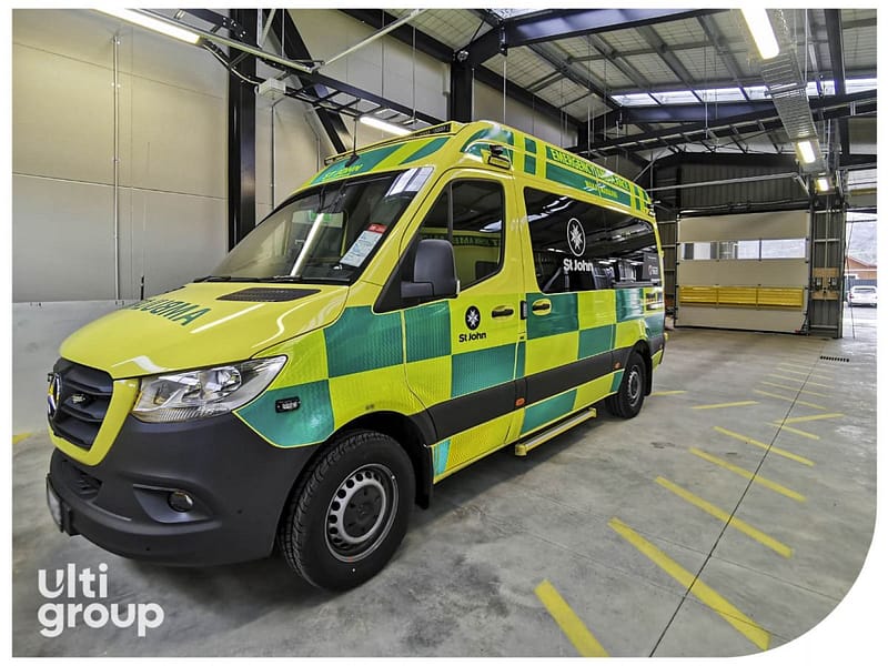 St John ambulance parked inside a facility with an Ulti Group sectional door.